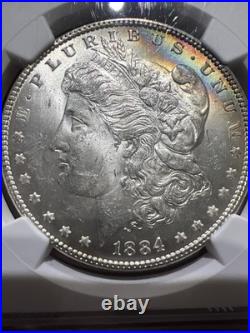 1884 NGC MS62 Morgan Silver Dollar with a Touch Of Duel Sided Rainbow Toning